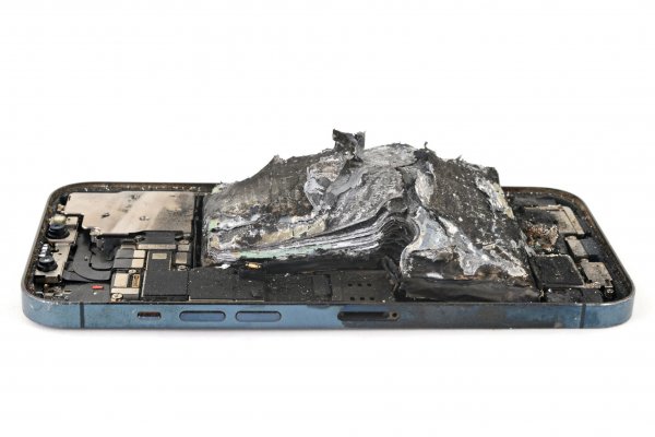 A charred iPhone 12 Pro battery after a thermal event showing the many burned layers of the Li-po battery.