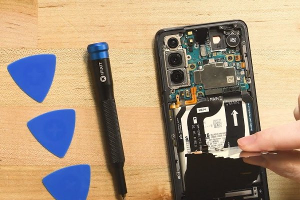 Partially opened Galaxy S21, driver, and picks